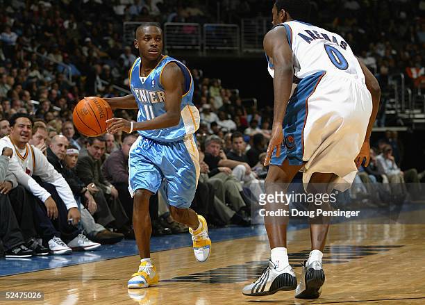 Earl Boykins of the Denver Nuggets moves the ball against Gilbert Arenas of the Washington Wizards December 8, 2004 at the MCI Center in Washington...