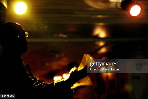 Bar patron gets up and performs with the band performing at St. Nick's Pub in the Harlem neighborhood May 5, 2004 in New York City. St. Nick's Pub in...