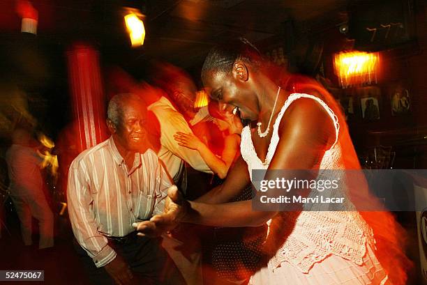 Club regulars swing dance at the Cotton Club in the Harlem neighborhood June 14, 2004 in New York City. The Cotton Club was one of Harlem's hot spots...