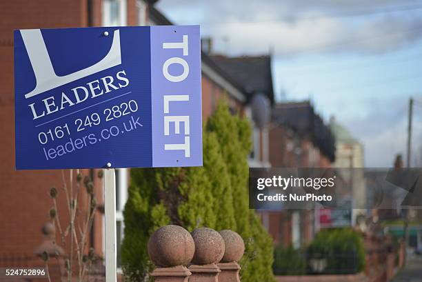 Light shining on a sign outside a property showing its availability on the housing market in Greater Manchester, Manchester, England, United Kingdom...
