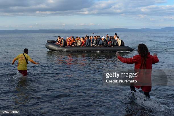 VOlunteers are helping as another boat with migrants arrives near Skala Sikamineas. Skala Sikamineas, Lesvos Island, Greece, on October 29, 2015.