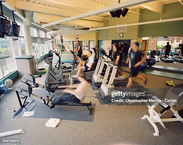 Employees of Electronic Arts, an entertainment software business, work out in the company gym. Electronic Arts has been voted one of the 100 best...