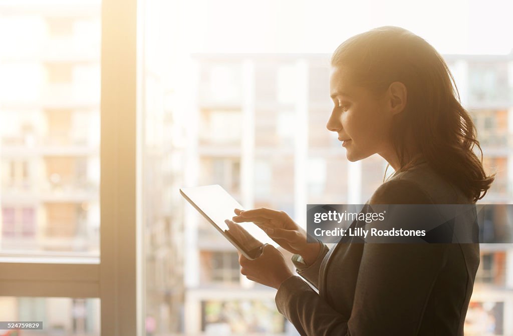 Young Woman Using Tablet Computer at Sunset