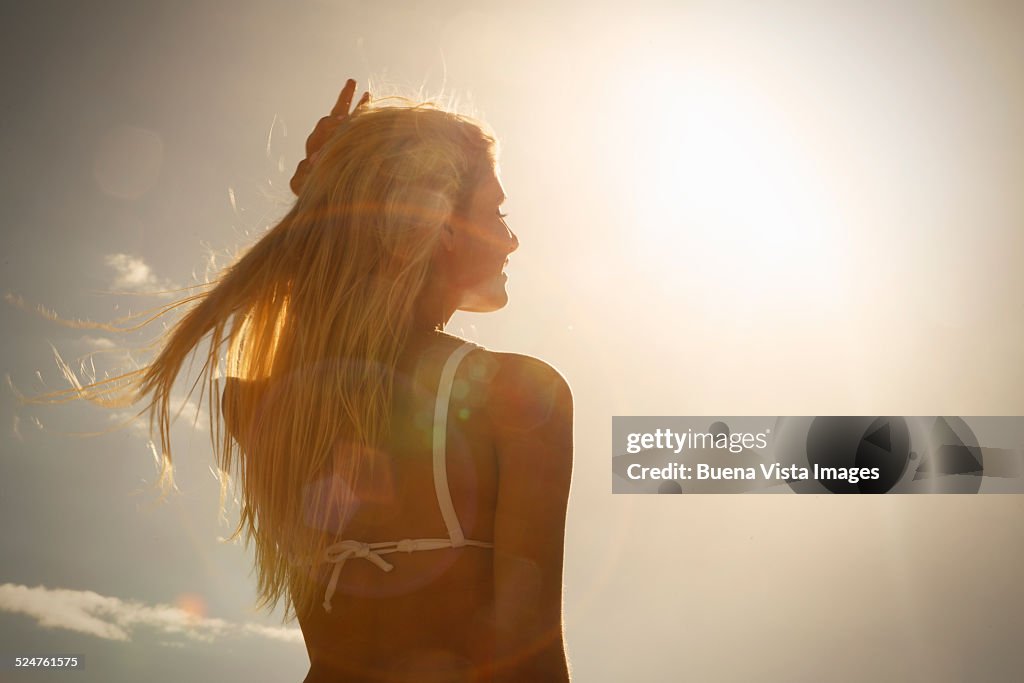 Woman on the beach at sunset