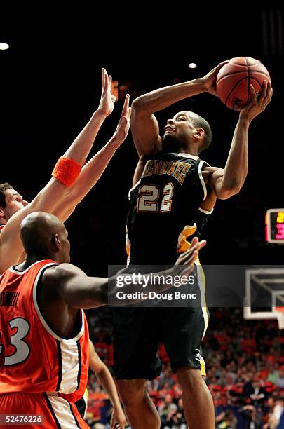 Ed McCants of the Wisconsin-Milwaukee Panthers shoots over the defense of the Illinois Fighting Illini in game one of the Chicago Regional in the...