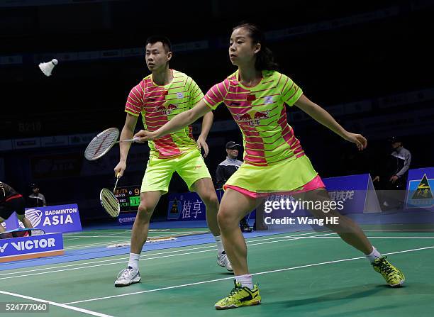 Ma Jin of china hits a return next to her partner Xu Chen during their mixed doubles match against Artur Niyazov and Veronica sorokina of Kazakhstan...