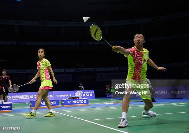 Xu Chen of china hits a return next to him partner Ma Jin during their mixed doubles match against Artur Niyazov and Veronica sorokina of Kazakhstan...