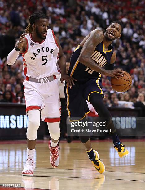 DeMarre Carroll defends against Paul George as the Toronto Raptors beat Indiana Pacers in game five 102-99 in their first round NBA playoff series at...