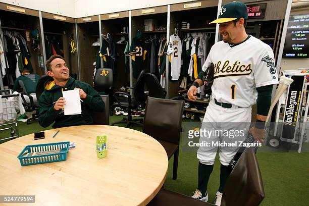 Sam Fuld and Billy Burns of the Oakland Athletics talk in the clubhouse prior to the game against the Los Angeles Angels of Anaheim at the Oakland...
