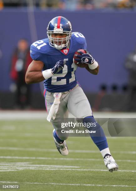 Tiki Barber of the New York Giants carries the ball during the game against the Pittsburgh Steelers at Giants Stadium on December 18, 2004 in East...