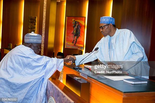 President Muhammadu Buhari congratulating INEC National Commissioner Alh. Baba Shettima Arfo shortly after his swearing in Abuja 9th Nov. 2015