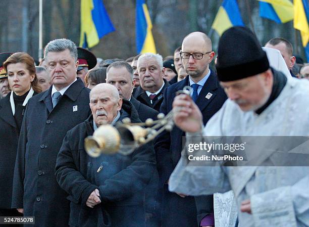 Ukrainian President Petro Poroshenko and Ukrainian Premier minister Arseny Yatsenyuk attend a memorial ceremony near a monument to the victims of the...