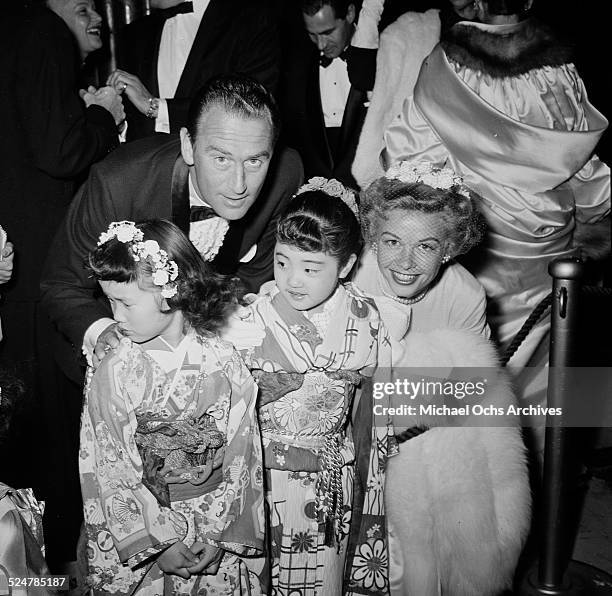Actress Vera-Ellen and husband Victor Rothschild pose with two little girls as they attend a movie premiere in Los Angeles,CA.