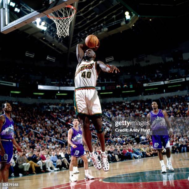 Sean Kemp of the Seattle Sonics goes up for a slam dunk against the Utah Jazz during an NBA game at Key Arena on December 1, 1996 in Seattle,...