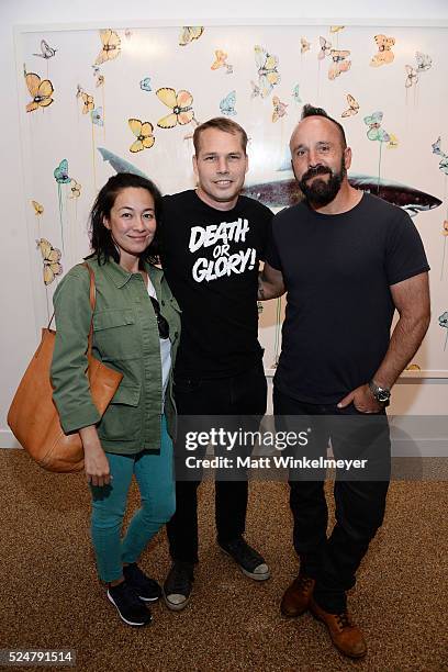 Amanda Fairey, artist Shepard Fairey, and photographer Michael Muller attend the Opening Reception for Michael Muller's book "Shark" hosted by...