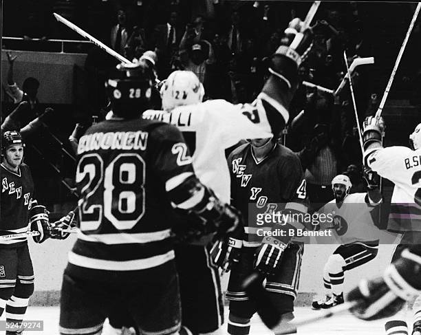 The New York Islanders celebrate Ken Morrow's overtime goal to defeat the rival New York Rangers in Game 5 of the Patrick Division semifinals at...