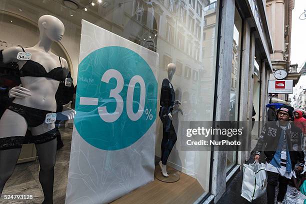 Man walks past a shop window offering generous discounts during the winter sales in downtown Rome, Italy, on January 5, 2016. The first day of winter...