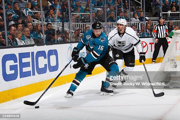 Nick Spaling of the San Jose Sharks skates with the puck against Jamie McBain of the Los Angeles Kings in Game Four of the Western Conference...