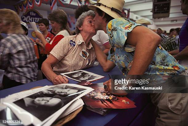 During the annual "Fan Fair" in Nashville, Jim Hager of the TV show "Hee-Haw" gives a fan a kiss. Thousands are drawn to the annual face-to-face...
