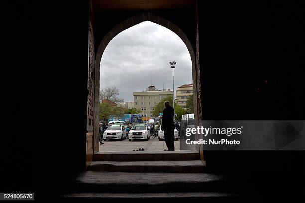 Man outside Aksaray Grand Mosque observing the preparations for the start of the third stage of of the 52nd Presidential Tour of Turkey 2016. On...