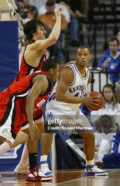 Chuck Hayes of the Kentucky Wildcats handles the ball under pressure from Andrew Bogut of the Utah Utes during the 2005 NCAA division 1 men's...