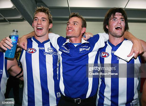 Drew Petrie, Dean Laidley and Leigh Brown sing the club song after the round one AFL match between the Kangaroos and the Carlton Blues at the Telstra...