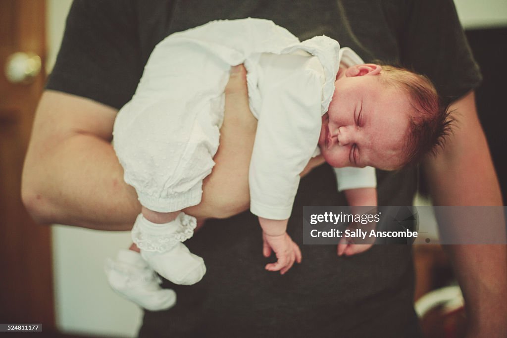 Father holding his newborn baby daughter