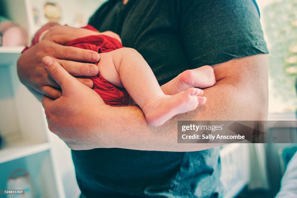 Father and holding his newborn baby girl