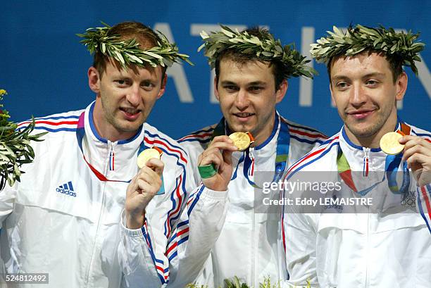 Athens 2004 - Olympic Games. Fencing. Men s team sabre final. The French team is Olympic champion. Podium. Gael Touya, Damien Touya and Julien Pillet...