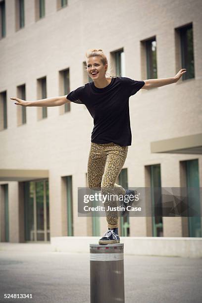 happy woman imitating a plane on a little pylon - pylon_(architecture) stock pictures, royalty-free photos & images