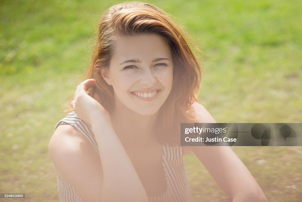 Woman smiling among the green grass