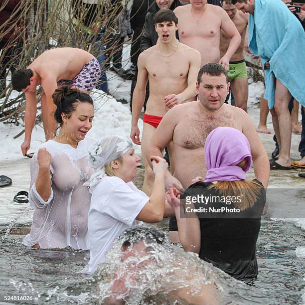 Orthodox believers plunge into the icy water of Dnipro river during Epiphany celebrations in Kiev, Ukraine, 19 January 2016. It is believed that all...