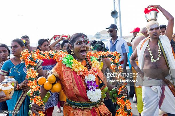 Hindu devotee gets her tongue pierced with medal rods Thaipusam festival is celebrated in honor of Hindu god Lord Murugan, is an annual procession by...