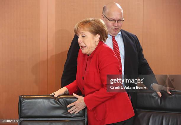 German Chancellor Angela Merkel and Minister of the Chancellery Peter Altmaier arrive for the weekly German federal Cabinet meeting on April 27, 2016...