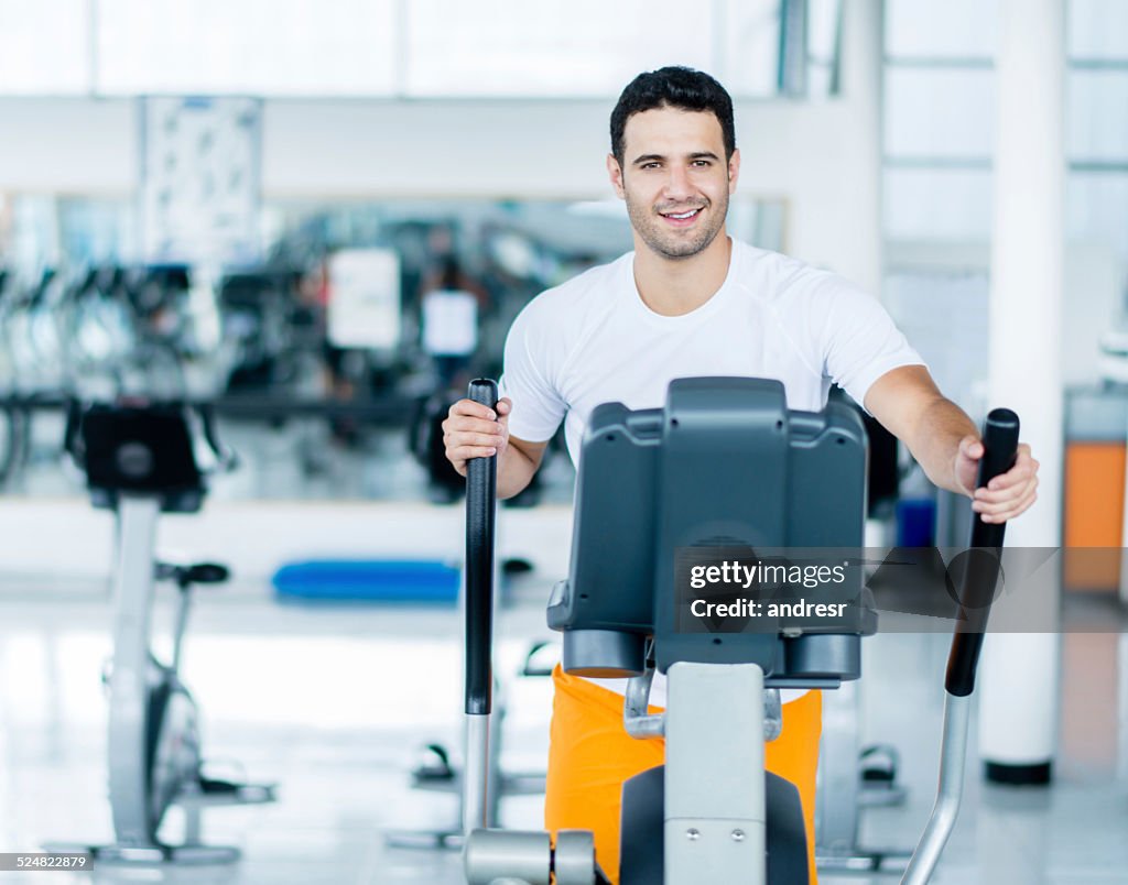 Man exercing on cross trainer