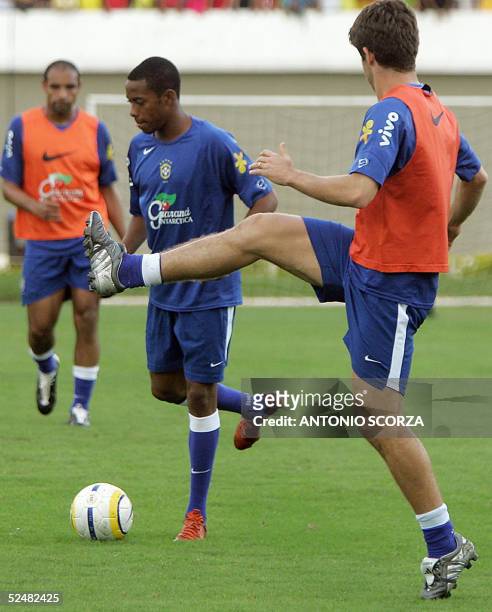 Brazilian soccer forward Robson de Souza , known as Robinho, fights for the ball with Juninho Pernambucano 26 March during a training session in...
