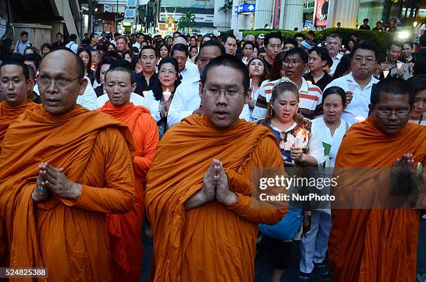 Monks and well-wishers gather near the Erawan Shrine to pay tribute to victims, who die in a bomb blast on August 17, in Bangkok, Thailand on August...