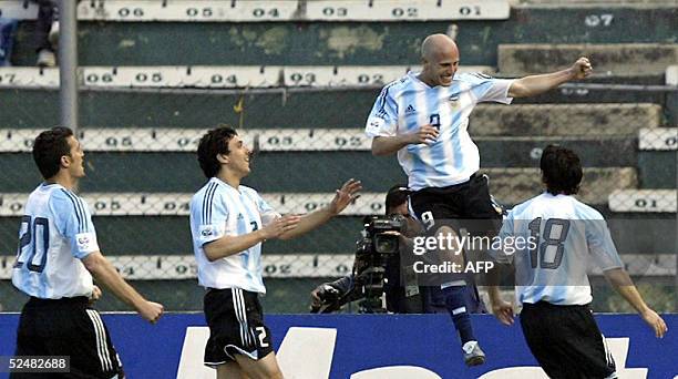 Argentine forward Luciano Figueroa celebrates with teammates Lionel Scaloni , Nicolas Burdisso and Luciano Galletti after scoring the first goal...