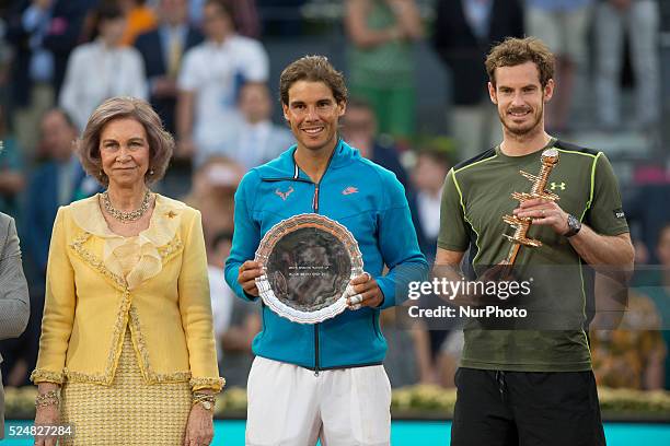 Andy Murray of Great Britain poses with his winners trophy after his straight sets victory against Rafael Nadal of Spain along with Queen Sofia of...