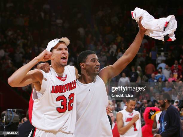 Francisco Garcia and Taquan Dean of the Louisville Cardinals celebrate after the Cardinals' victory over the West Virginia Mountaineers in overtime...