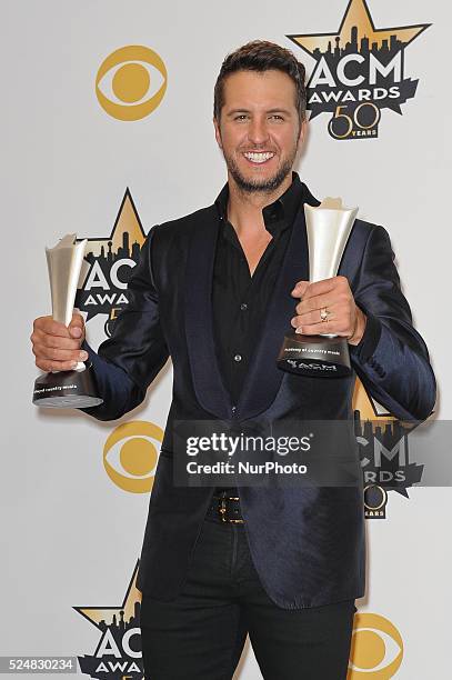 Musician Luke Bryan, winner of the Entertainer of the Year Award; and Vocal Event of the Year Award for 'This Is How We Roll', poses in the press...