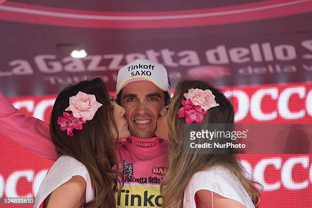 Two hostesses kiss overall leader Spain's Alberto Contador as he celebrates on the podium after winning the 98th Giro d'Italia, Tour of Italy cycling...