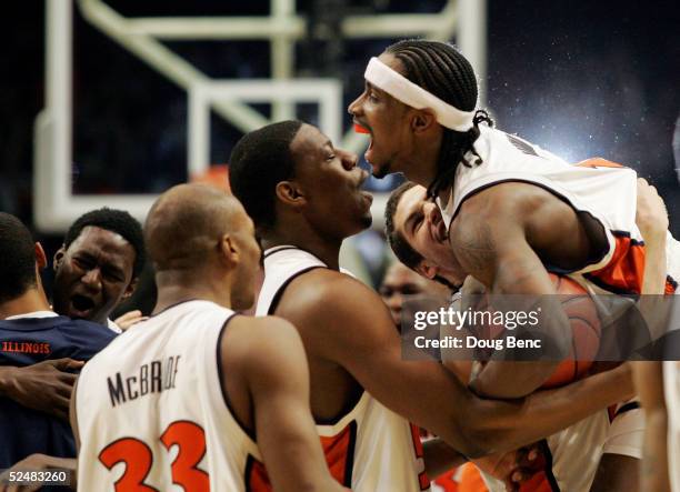 Dee Brown of the Illinois Fighting Illini is lifted up by his teammates in celebration of their win over the Arizona Wildcats in the Chicago Regional...