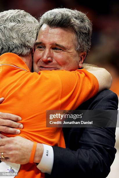 Head coach Bruce Weber of the Illinois Fighting Illini hugs his brother David Weber as they celebrate after victory over the Arizona Wildcats in the...