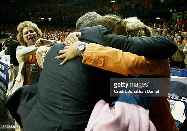 Head coach Bruce Weber of the Illinois Fighting Illini hugs his daughters while his wife Megan Weber, L, runs toward them after victory over the...