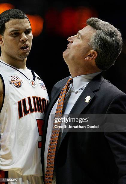 Deron Williams of the Illinois Fighting Illini gets a chest bump from head coach Bruce Weber after a play against the Arizona Wildcats in the Chicago...