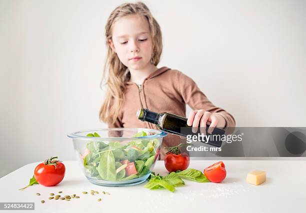 girl preparing fresh salad - salad bowl stock pictures, royalty-free photos & images