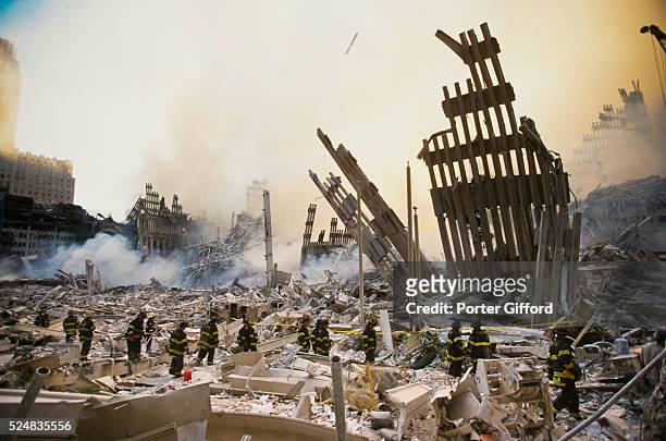 The rubble of the World Trade Center smoulders following a terrorist attack September 11, 2001 in New York. A hijacked plane crashed into and...