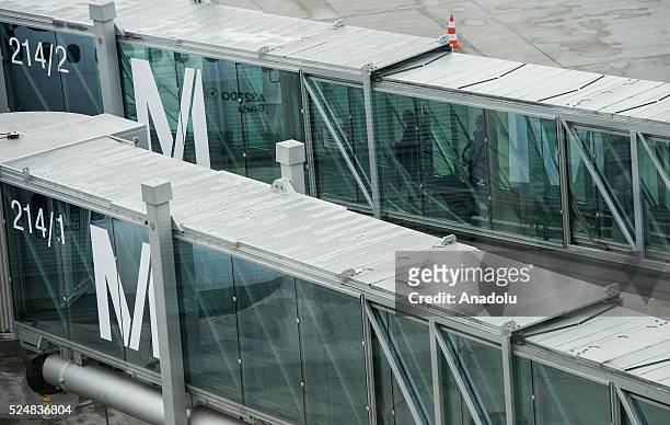 Passengers pass along a gangway to board a plane the the Munich Airport affected by strike action, in Munich, Germany on April 27, 2016.