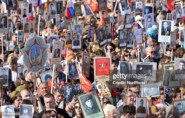 Thusands of locals take part in a walk-event through central Moscow holding portraits of their relatives who fought in World War II, as Russia...